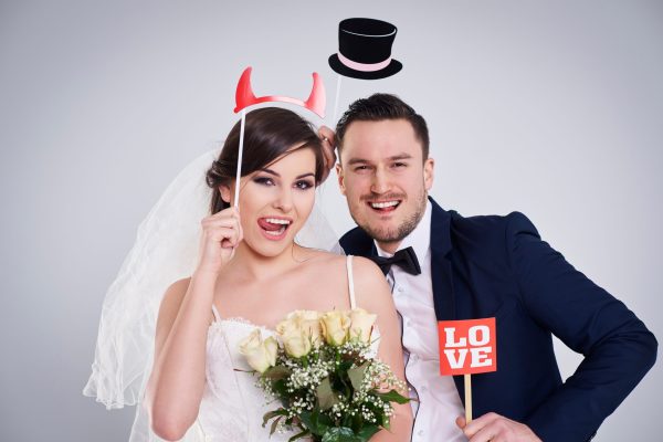 Bride and bridegroom making funny faces