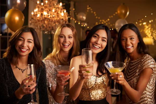 Female Friends Celebrating At Party Make Toast To Camera