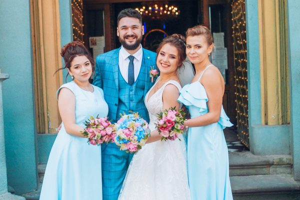 bride and groom newlyweds with happy groomsmans and bridesmaids posing at church after luxury wedding ceremony